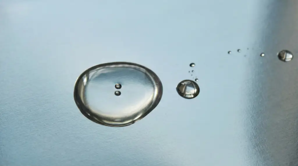 Clear drops on a light surface.
